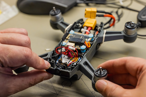 Drone opened to repair crash damage. The top shell has been removed to gain access to the internals of the drone.
